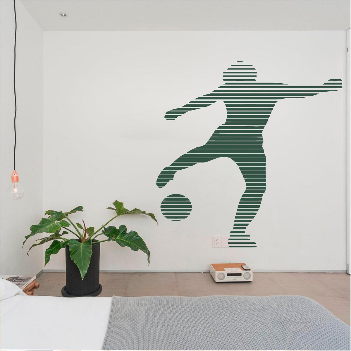 Green striped footballer wall decal above a bed