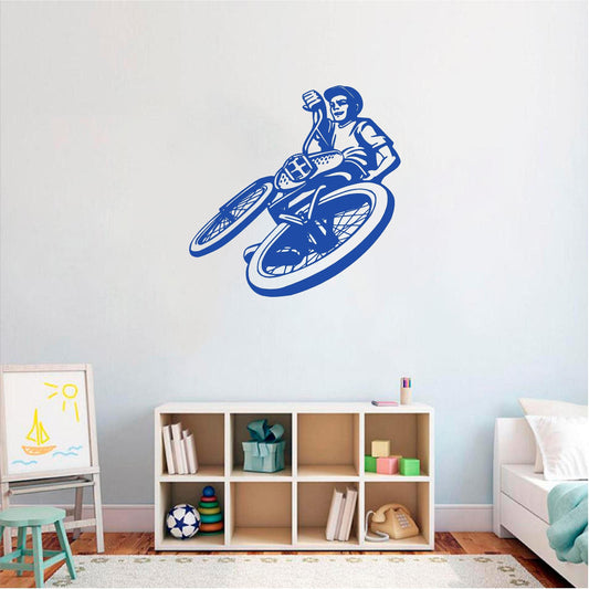 Blue BMX rider wall decal above bedroom shelving