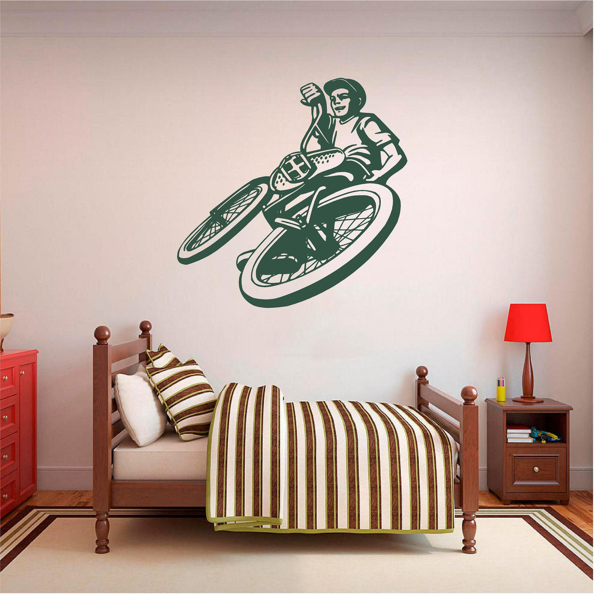 Green BMX rider wall decal above a striped bed