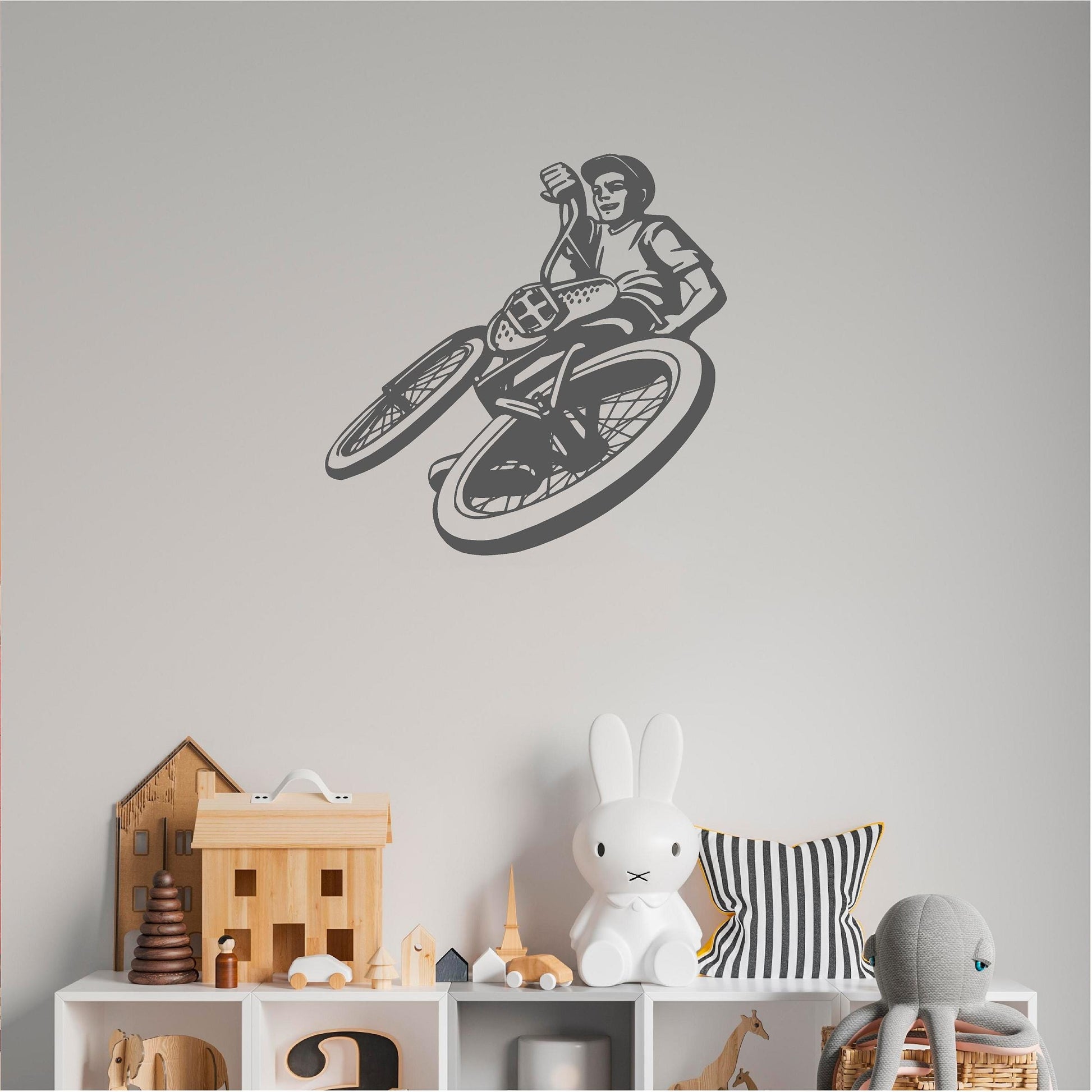 Grey BMX rider wall decal above toy shelving