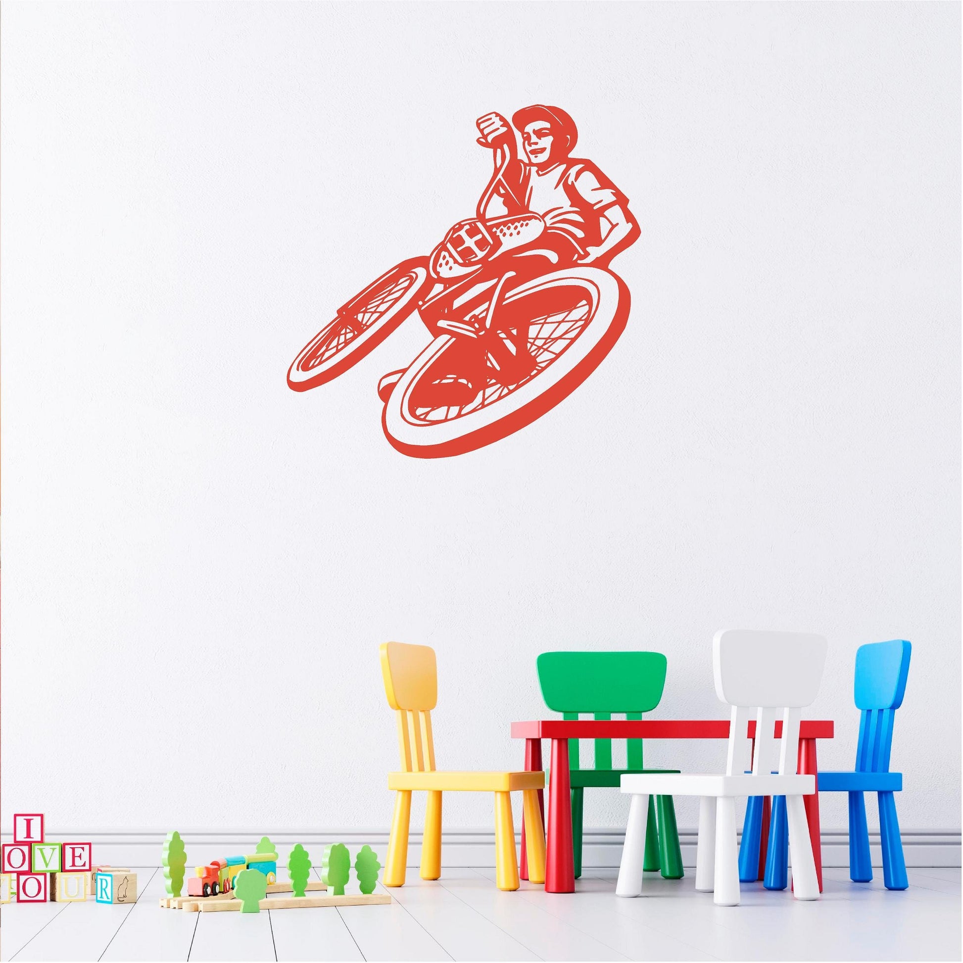 Orange BMX rider wall decal above a children's table