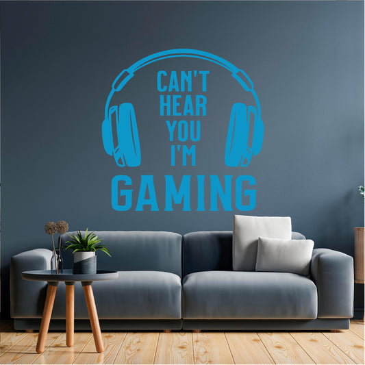 Blue Can't Hear You I'm Gaming wall decal above a grey sofa