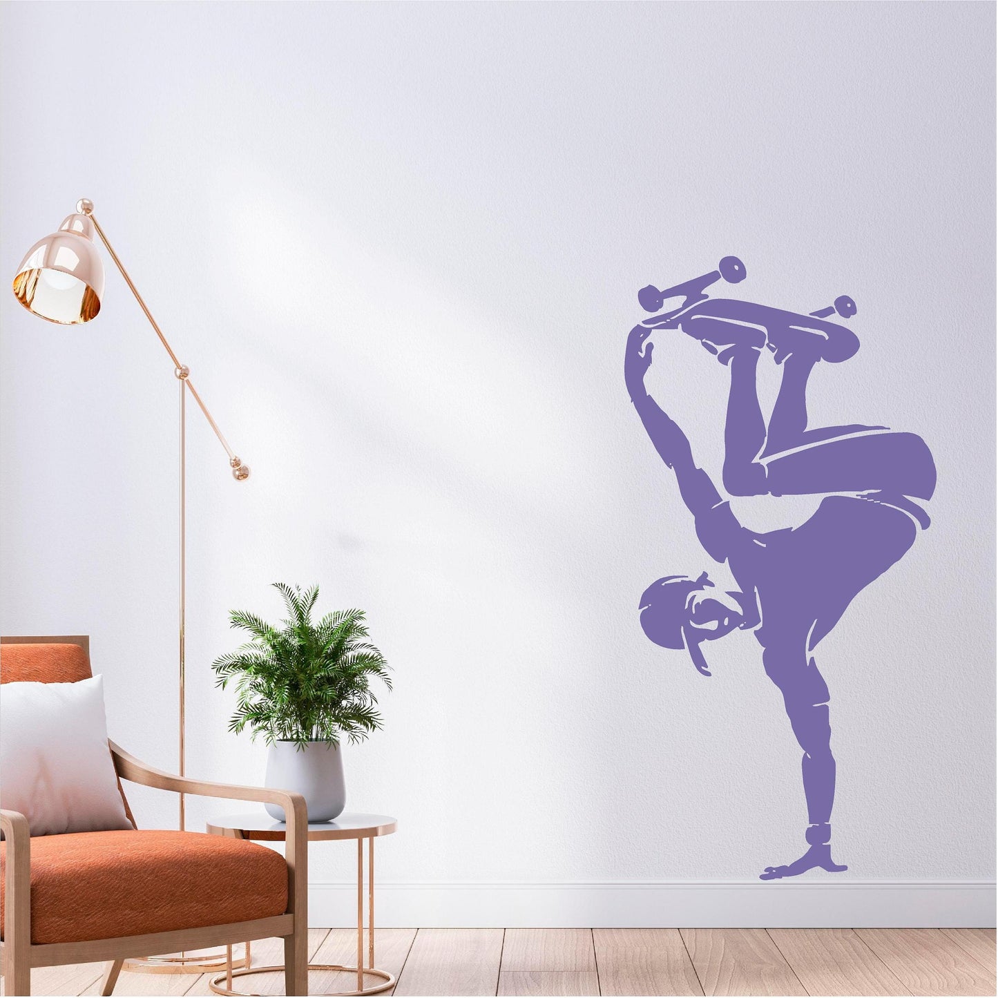 Lilac skateboarder handplant wall decal beside an orange chair