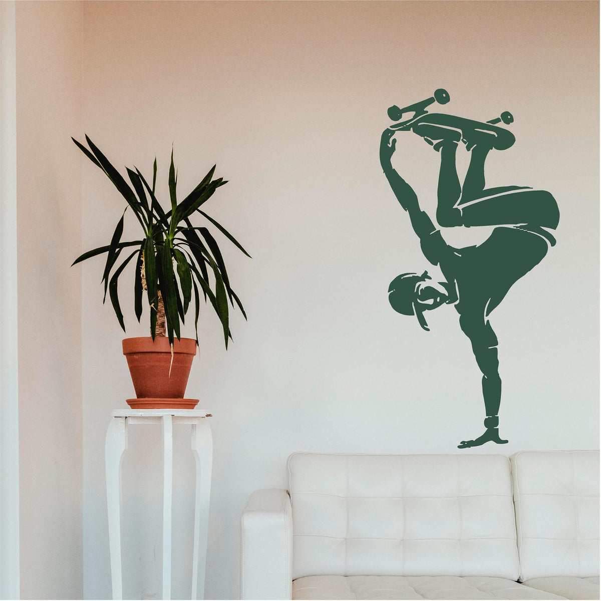 Green skateboarder handplant wall decal above a pale sofa