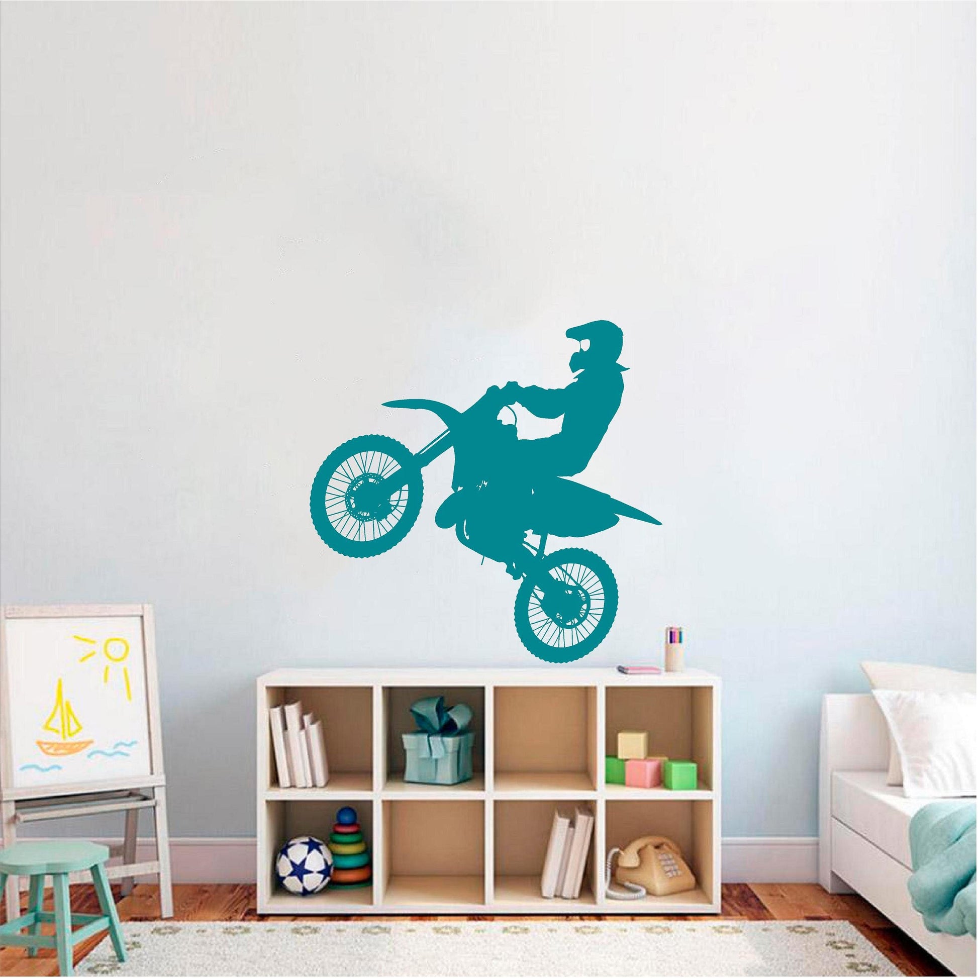 Turquoise motocross rider wall decal above bedroom shelving