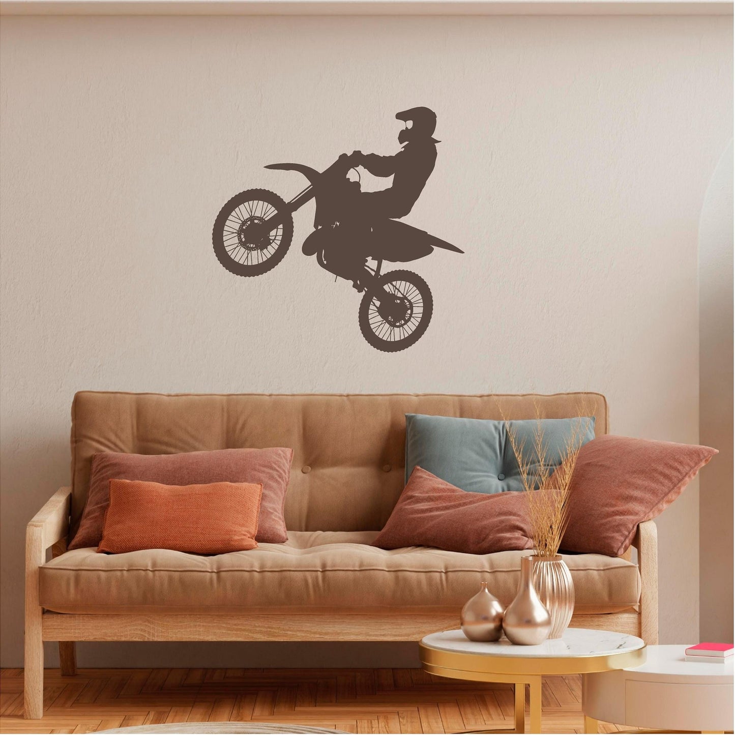 Brown motocross rider wall decal above a tan sofa