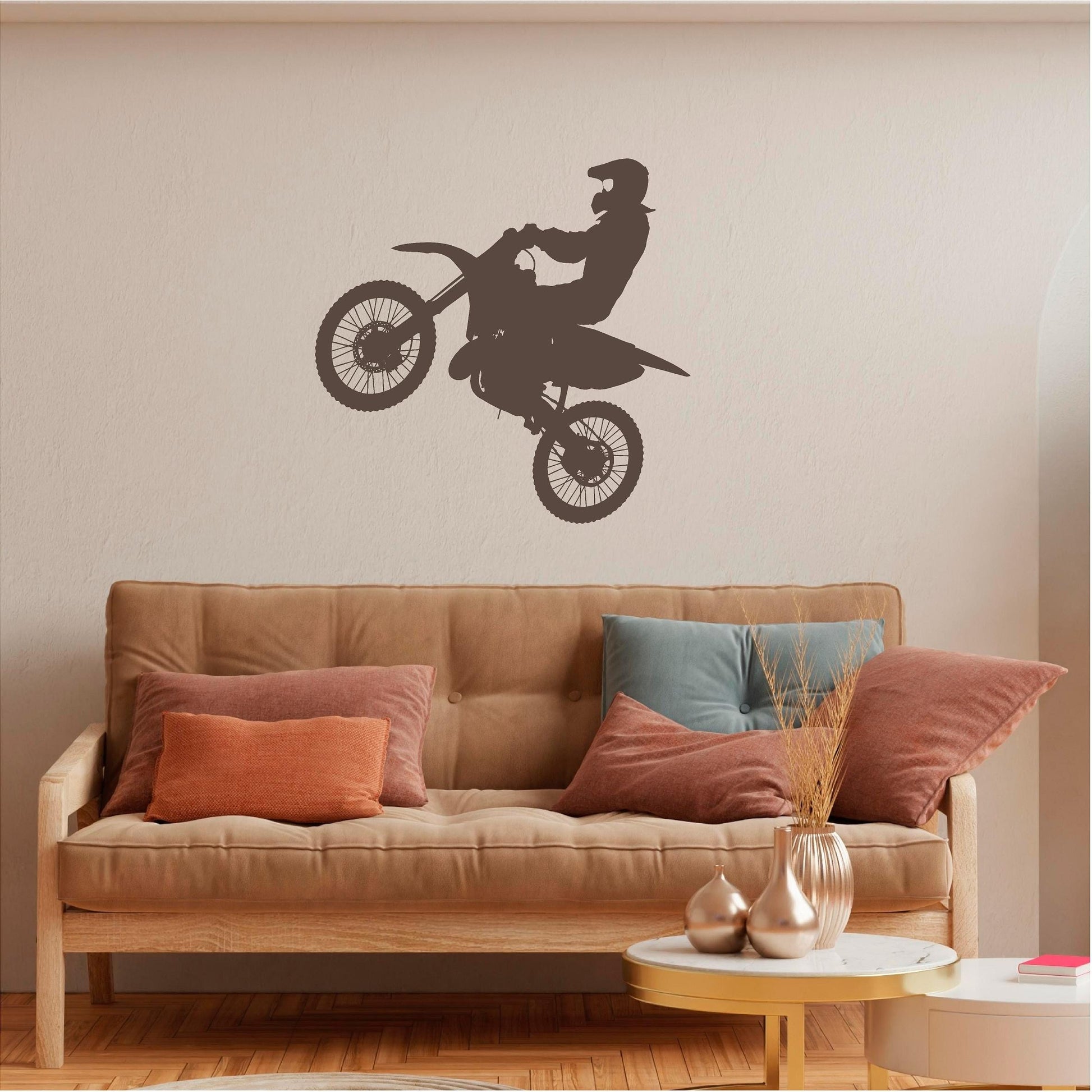Brown motocross rider wall decal above a tan sofa