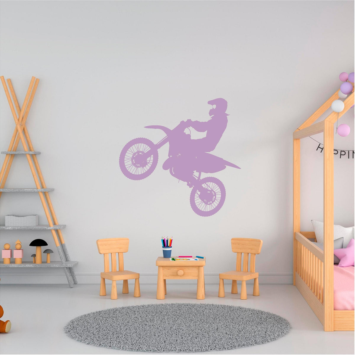 Lilac motocross rider wall decal above a children's table