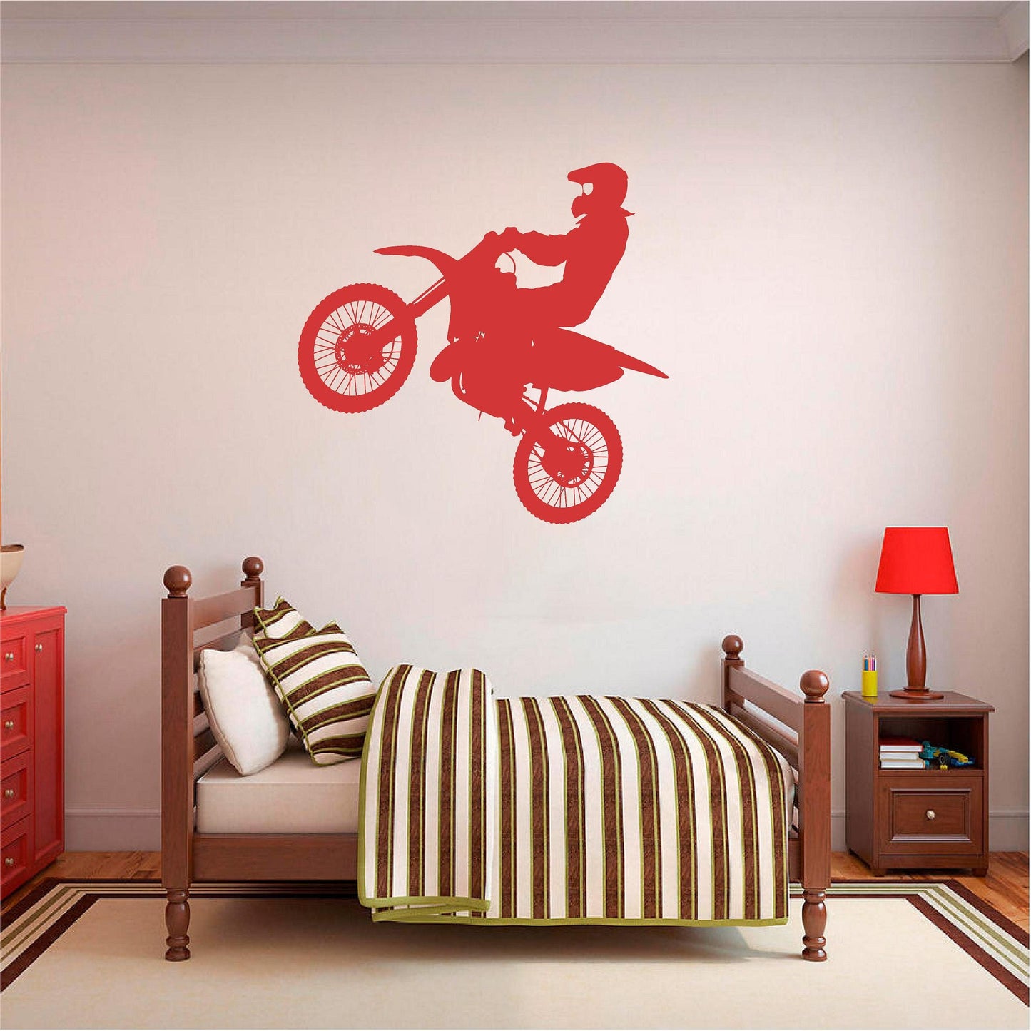 Red motocross rider wall decal above a striped bed