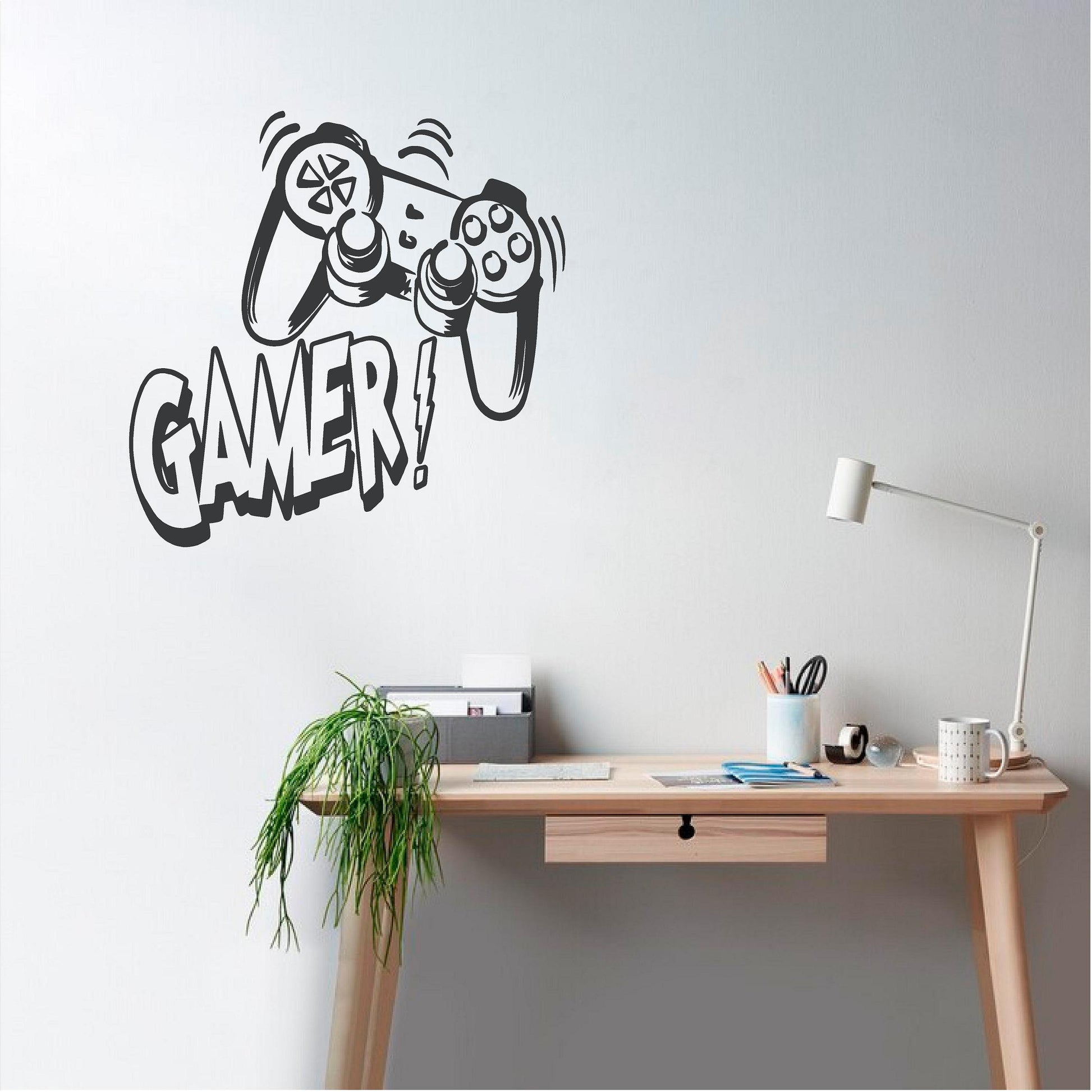Black Gamer controller wall decal beside a wooden desk