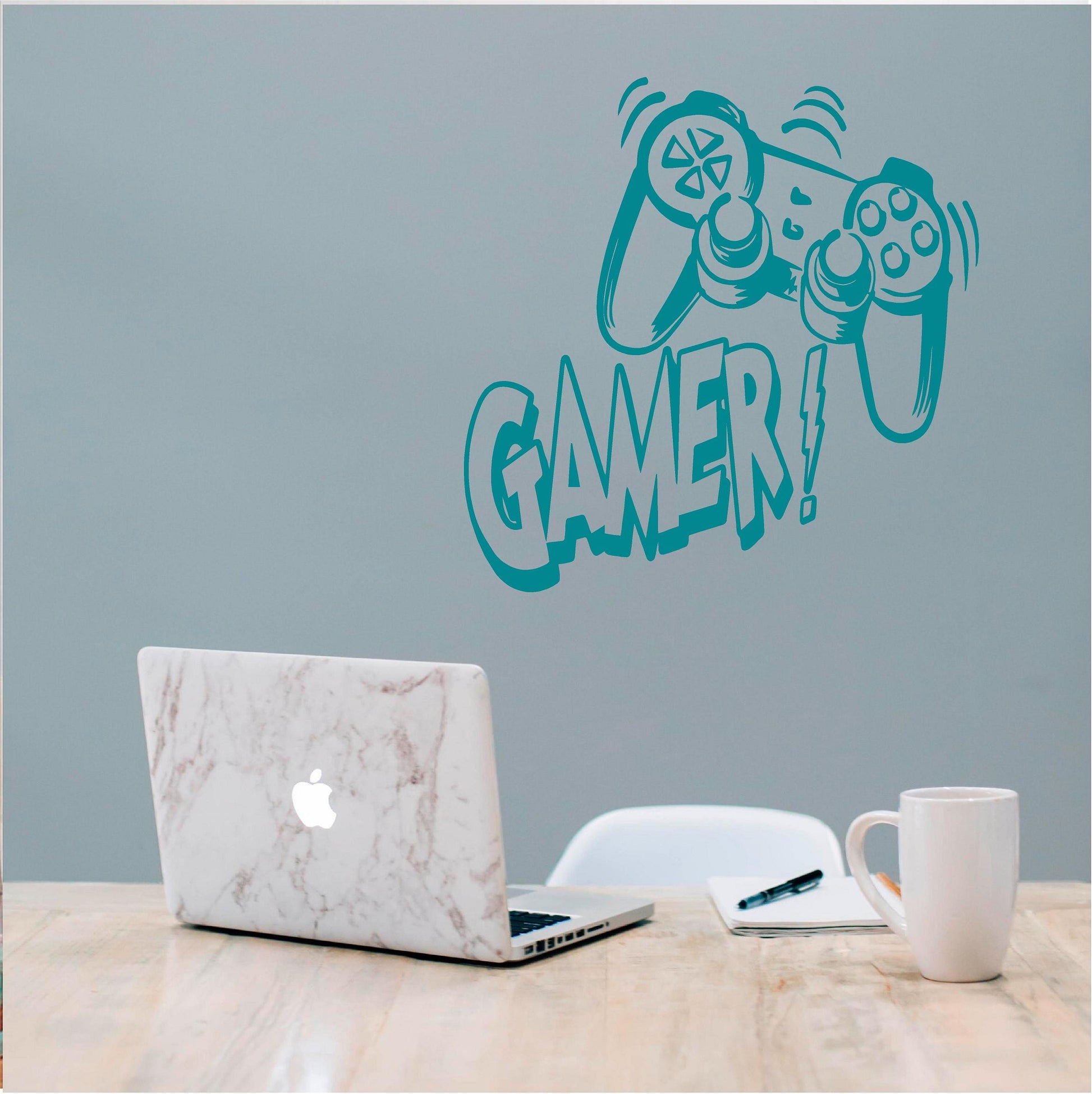 Turquoise Gamer controller wall decal above a laptop desk