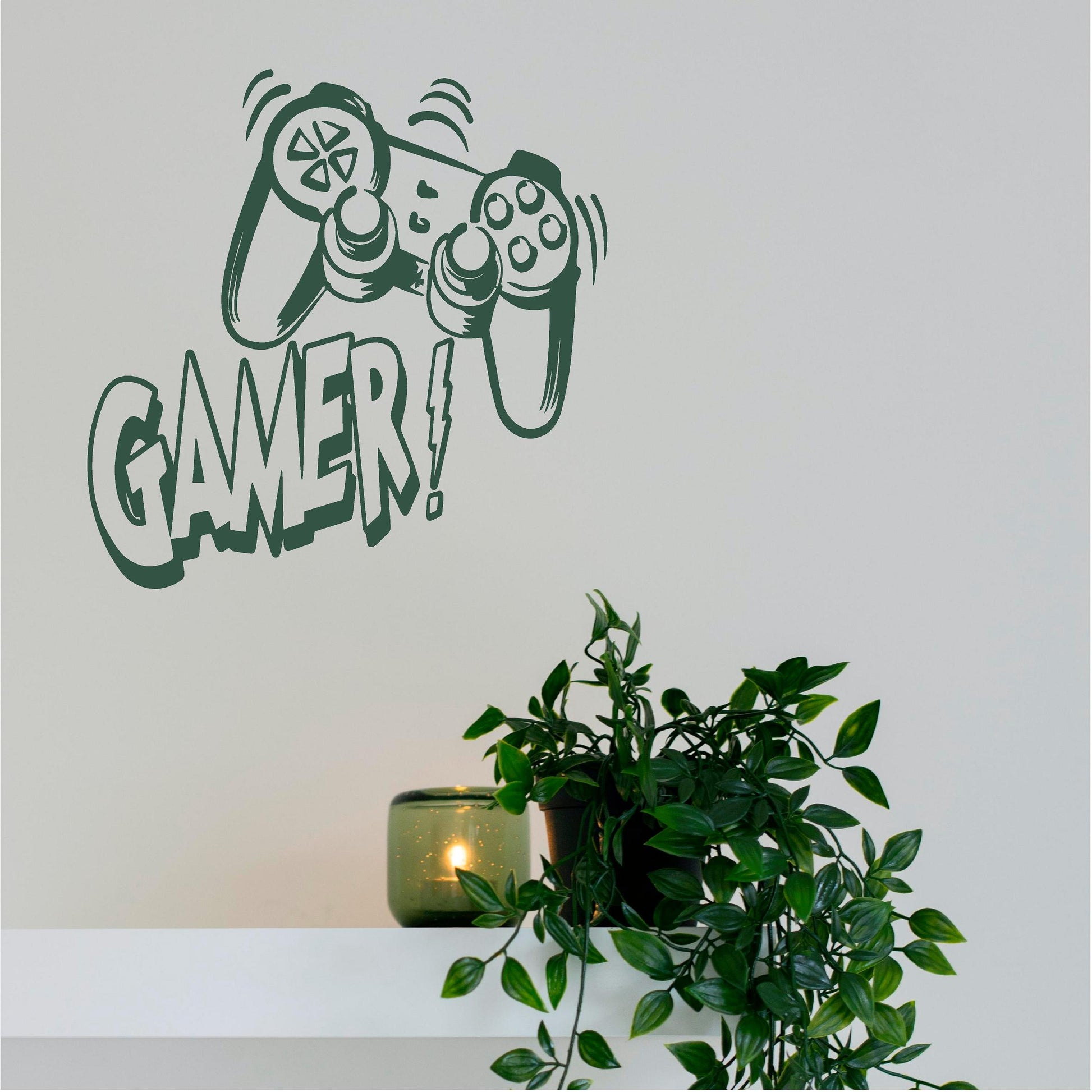 Green Gamer controller wall decal above a shelf with plants