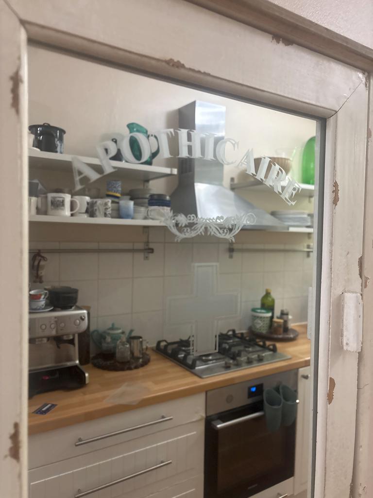 Apothicaire glass door — original project photograph
