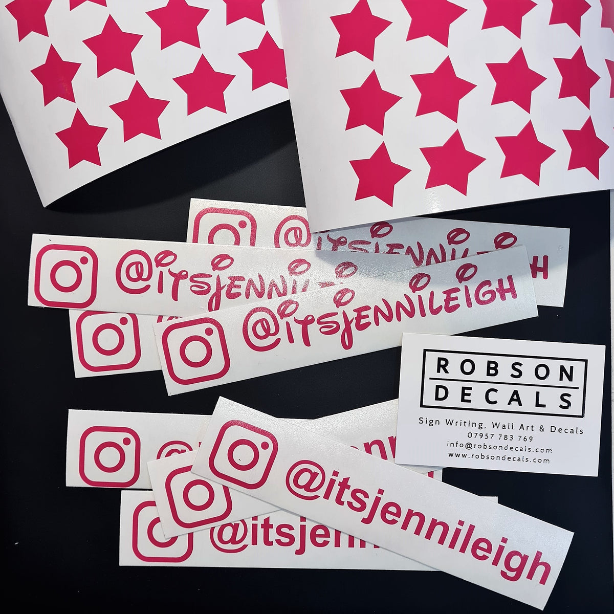 Personalised pink star helmet — prepared vinyl lettering or artwork, workshop photograph