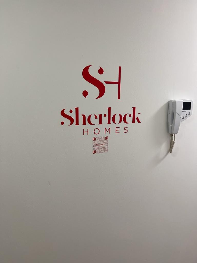 Sherlock Homes wall logo — original project photograph
