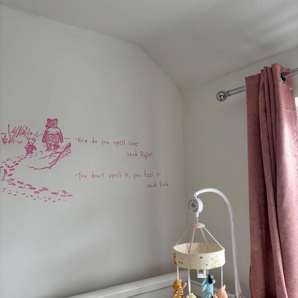 Pink illustrated quote decal on a nursery wall beside curtains.