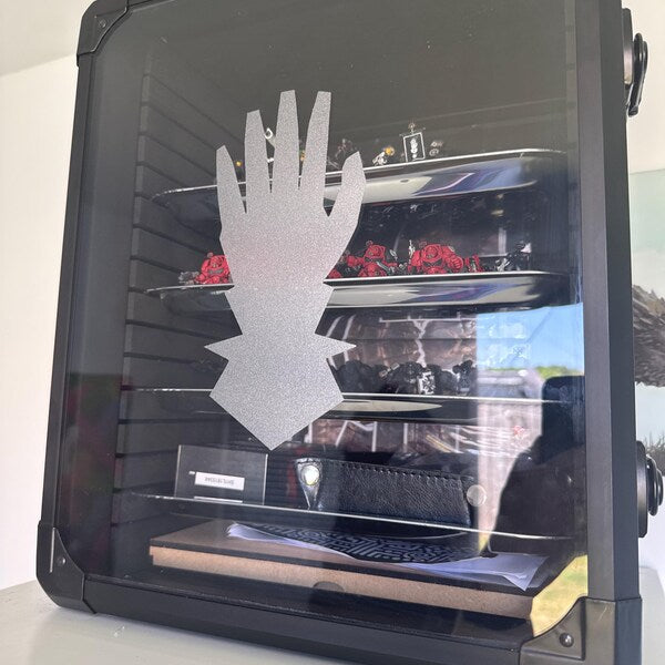 Pale hand silhouette decal on the side of a black equipment case.