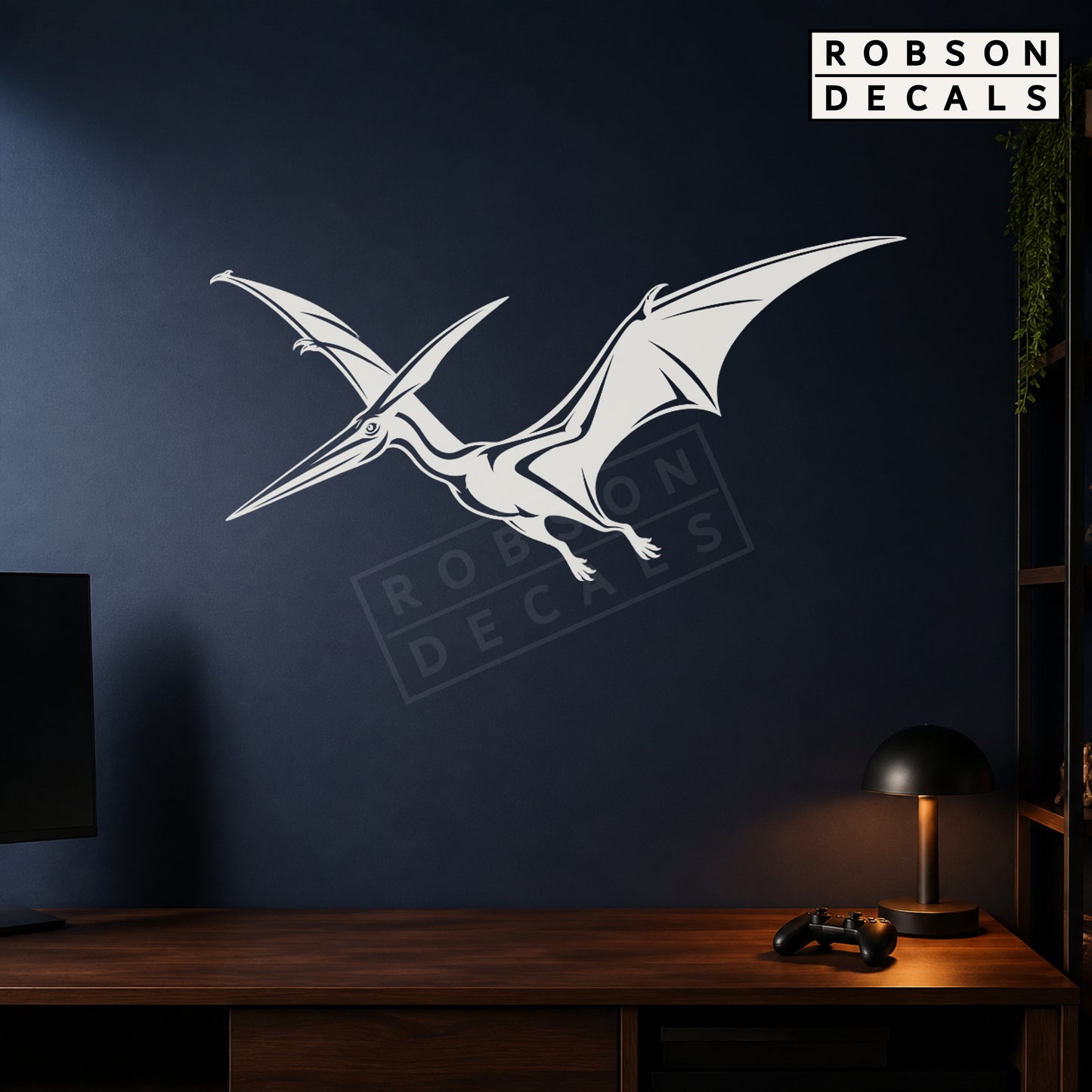 White flying pterodactyl wall decal on a navy games room wall, styled Robson Decals mockup