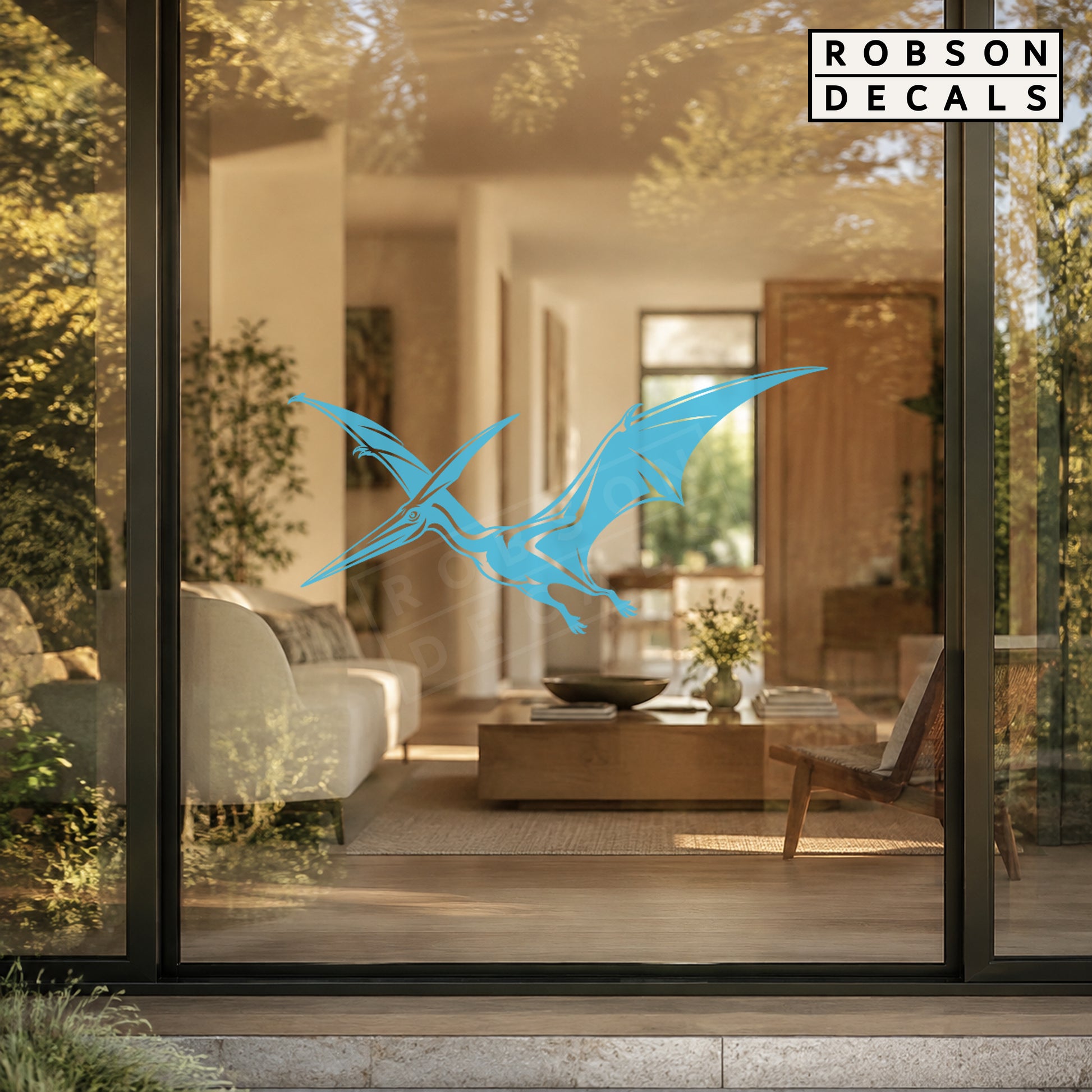 Pastel blue flying pterodactyl decal on clear patio-door glass, styled Robson Decals mockup