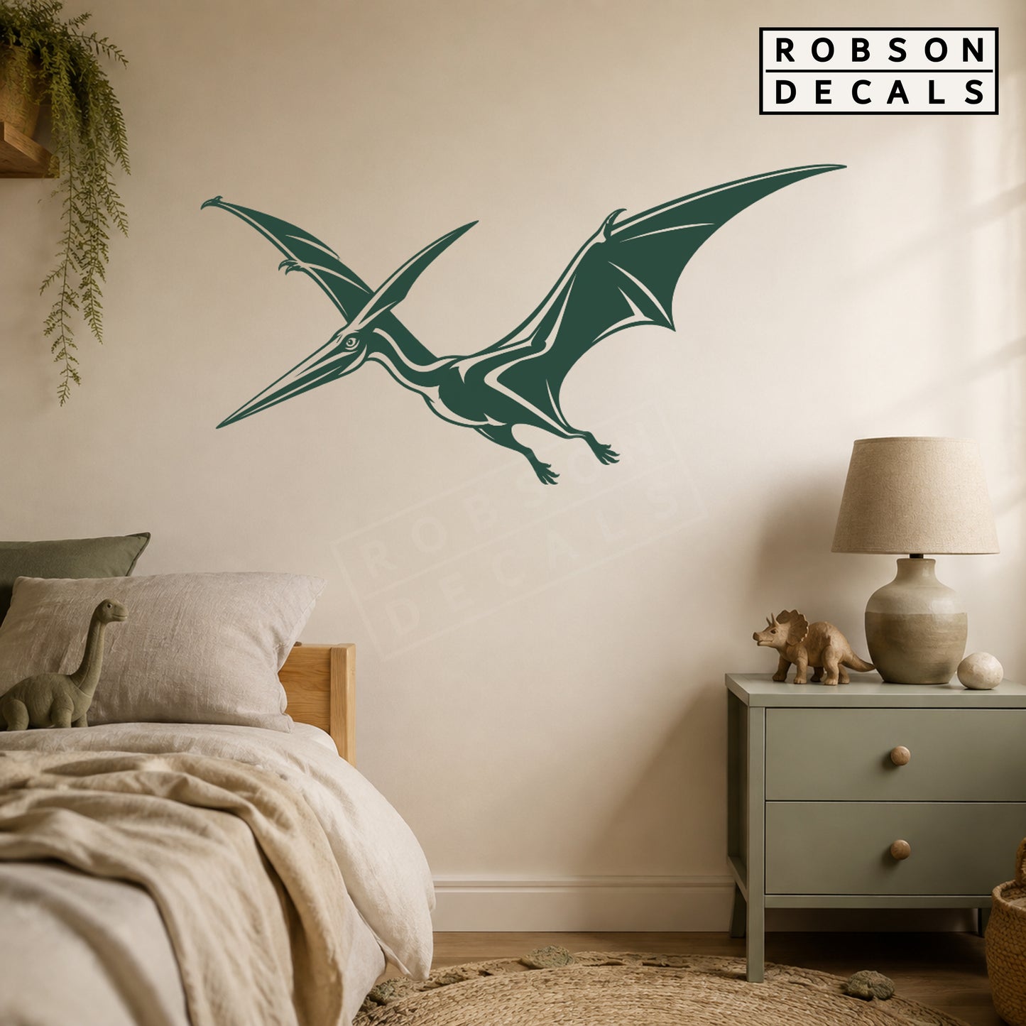 Forest green flying pterodactyl wall decal in a neutral bedroom, styled Robson Decals mockup