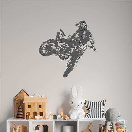 Grey motocross rider wall decal above a shelf in a child’s room