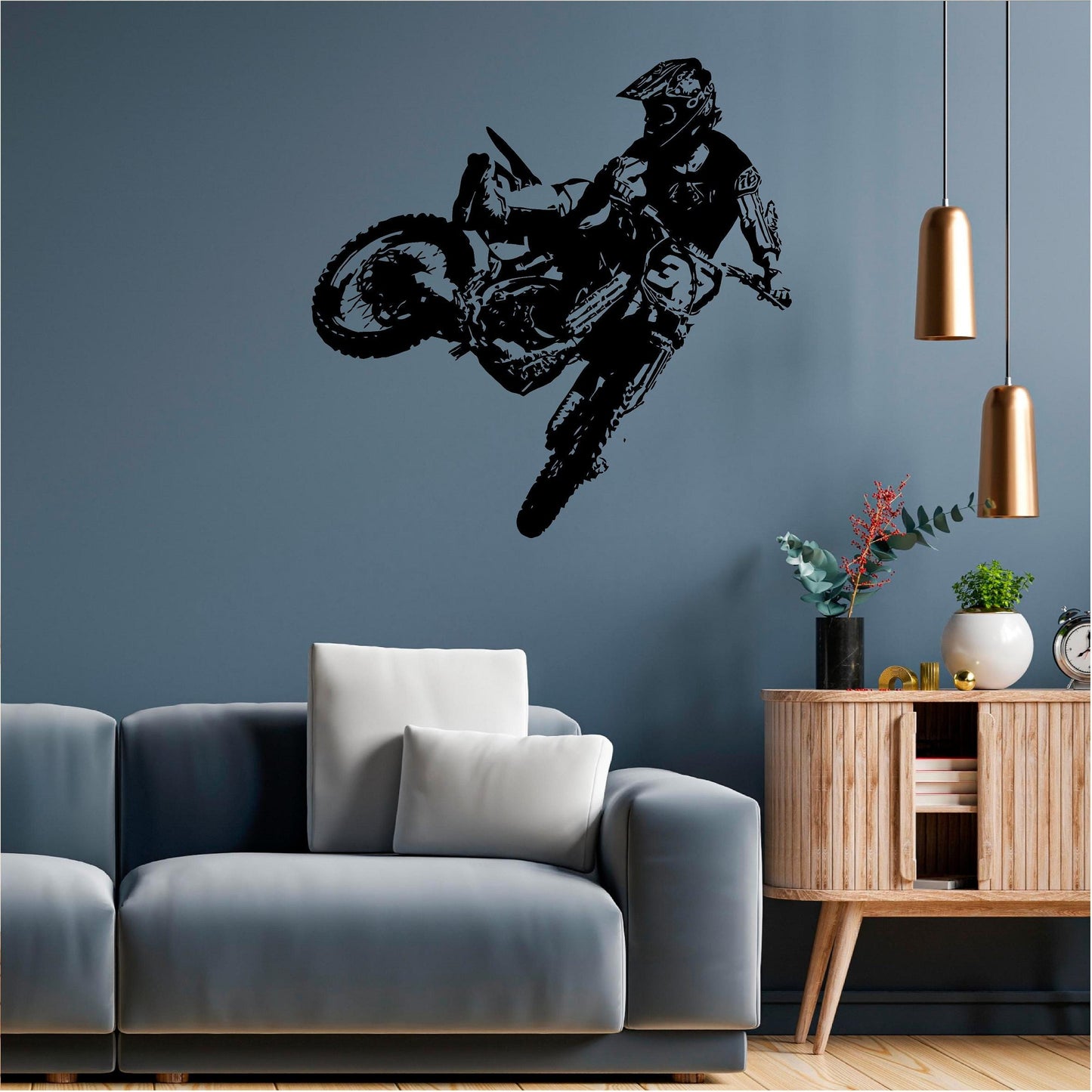 Black motocross rider wall decal on a blue living room wall