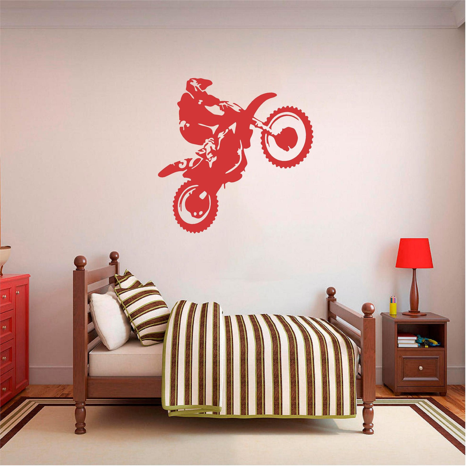 Red motorbike wheelie rider wall decal above a wooden single bed.