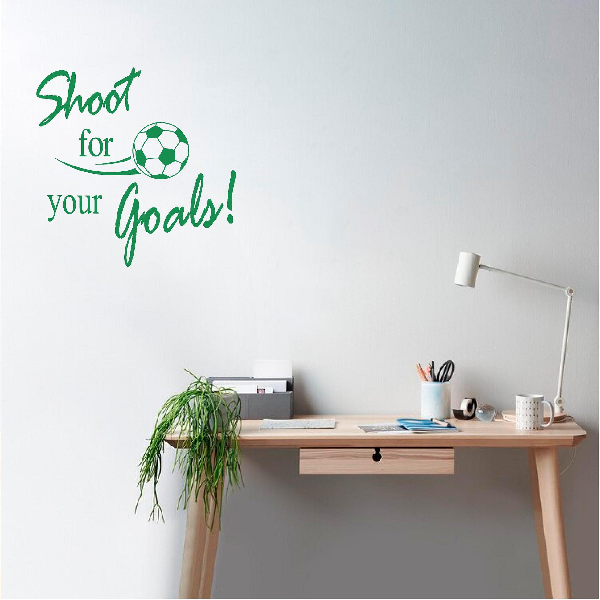 Green Shoot for your Goals football wall decal beside a study desk