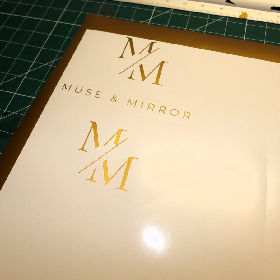 Close-up of gold Muse and Mirror vinyl lettering prepared in the Robson Decals workshop